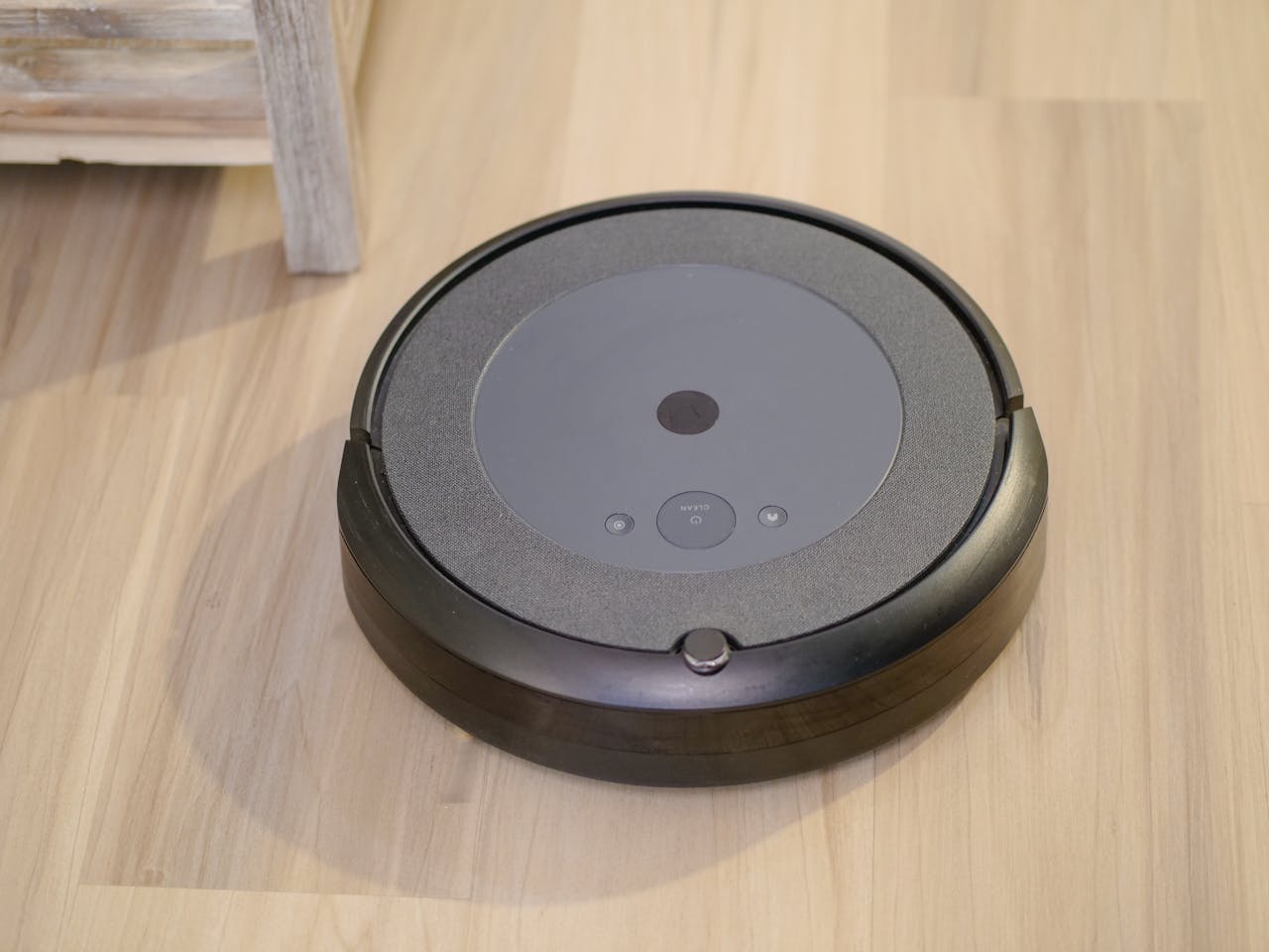 High-tech robotic vacuum cleaner efficiently cleaning modern floor indoors.
